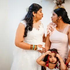 A funny face-off between the bride, her bridesmaid, and a very curious flower girl. Kids always bring an element of surprise to weddings.