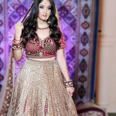 This is a classic Marwari lehenga with a red velvet blouse and a heavily embroidered gold skirt. It's a traditional and regal option for your wedding day.
