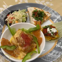 A plate from one of our tasting events, showcasing a variety of our offerings, from nachos and quesadillas to our innovative spot idli.