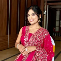 A full view of this elegant look. The hairstyle is kept soft and romantic to balance the vibrant, embroidered lehenga.