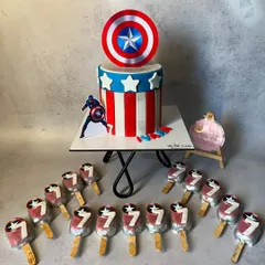 This Captain America themed cake was part of a set for a 7th birthday party. The cake features the iconic shield and stripes, and I also made matching cakesicles for all the guests.