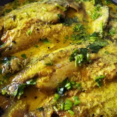 Shorshe Pabda, a classic Bengali fish curry. Delicate Pabda fish is gently simmered in a sharp mustard sauce, garnished with fresh coriander. This dish is a favourite among my patrons for its authentic taste and beautiful presentation.