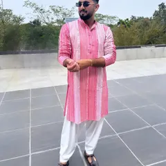 This is my signature 'Desi Kalakaar' style. A vibrant, embellished pink kurta paired with a classic white salwar is the perfect look for a daytime wedding event like a Haldi or Mehendi ceremony.