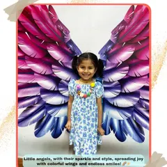 Our little angels spreading joy. We love seeing our students' happy faces and endless smiles in front of our colorful wings backdrop.