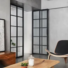 In AD House, we used black-framed glass partitions to separate spaces while maintaining a sense of openness and light. This view from the entrance into the living room frames the space like a picture.