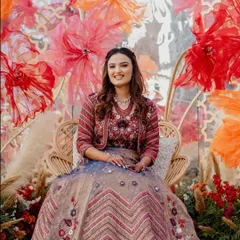 A bride glowing amidst our 'Terracotta Tales' decor. We designed this boho-chic Haldi with rattan peacock chairs and a backdrop of handmade paper flowers to create picture-perfect, Pinterest-worthy moments.