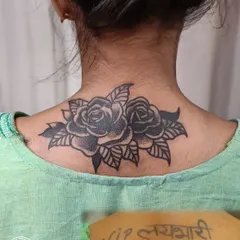 Out with the old, in with the beautiful. This client wanted to cover old script on her neck. We chose a classic black and grey rose design, carefully shaped to flow with her body and completely obscure the tattoo underneath, giving her a fresh start with a timeless piece of art.