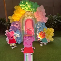 A cheerful Peppa Pig theme, perfect for toddlers. This outdoor setup features a rainbow balloon arch against a custom backdrop, with life-sized cutouts of Peppa Pig and her friends.