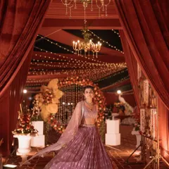 A stunning bride framed by the grand, red draped entrance I designed for her wedding. It's an honor to create beautiful backdrops for such important life moments.