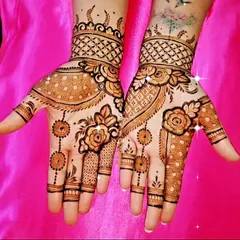 This design combines shaded roses with delicate dot-work and geometric net patterns. It's a modern and romantic style that is very popular for engagement parties and sangeet functions.