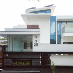 The clean, contemporary facade of Villa 9/21B in Faridabad. This project highlights our expertise in modern villa architecture, using a minimalist palette of white render, glass, and wood accents to create a home that is both striking and serene.