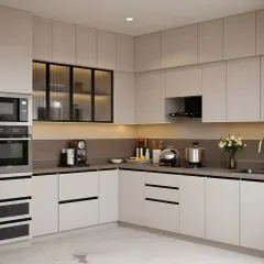 A full view of a spacious L-shaped kitchen, showcasing our expertise in appliance integration. The design includes dedicated housing for a microwave and oven, ensuring a seamless and uncluttered look. The dual-tone cabinets and handleless design contribute to the modern aesthetic.