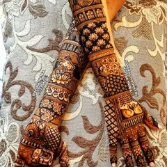 A bride deserves nothing less than perfection. This is a look at a complete bridal mehndi, featuring symmetrical patterns, traditional motifs like swans and lotuses, and intricate details covering the full arms for a truly royal look.
