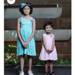 Here you can see how my crochet flower patches look on children's dresses. The patches add a charming, handmade detail to simple outfits, making them unique and special.