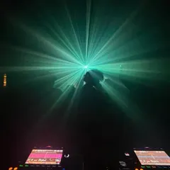 The view from my DJ booth during the queer-friendly night in Bangalore. A single beam of light illuminates a dancer, creating a powerful, almost spiritual moment. This is the kind of transcendental vibe I strive to create.