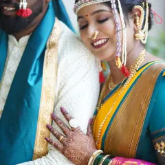 A close-up of the bride's embrace, showcasing her intricate mehndi, green bangles, and the flawless, long-lasting lip color that completes her look.