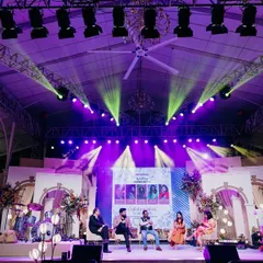 The main stage for the Bangalore Wedding Fraternity meetup. The design incorporated architectural elements and dramatic lighting to create a professional and engaging setting for panel discussions.
