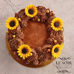 A rich and decadent take on the sunflower theme. This half-kg Intense Dark Chocolate Truffle cake is finished with chocolate buttercream and decorated with bright yellow sugar sunflowers.
