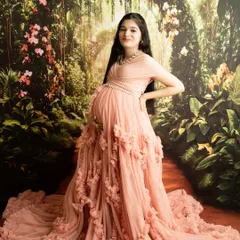A full-length portrait showcasing a stunning ruffled gown against a garden backdrop. This pose is designed to be powerful and elegant.