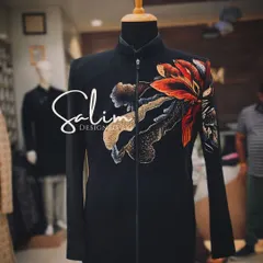 A close-up of a hand-painted floral motif on a black Jodhpuri jacket. The blend of colors and brushwork shows how I use painting to create unique, artistic garments.