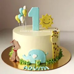 This sweet and simple first birthday cake features a cheerful sun and friendly fondant animals. The pastel colors and cute characters like the giraffe, elephant, and dog create an adorable safari theme for a happy milestone celebration.