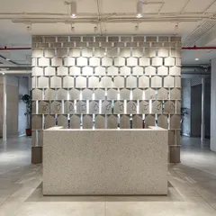 The reception at the Penguin India office immediately sets a narrative tone. A custom-designed screen made of book-like modules, some featuring the iconic dancing penguin, creates a playful yet sophisticated welcome for a company dedicated to the world of literature.