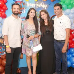Friends and family gather for a group photo, all smiles at a fun and hassle-free birthday celebration.
