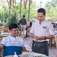 A guest sharing a smile with one of our team members. It's this friendly, personal interaction that makes the experience here special.