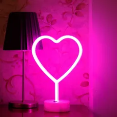 A simple and sweet pink neon heart light. This can be used as part of a larger decoration or as a standalone piece to add a touch of romance to any room.
