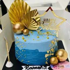 A beautiful blue and gold ombre cake, perfect for a stylish birthday celebration.