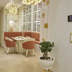 A view of the dining nook from the hallway, showing how it's neatly tucked into a corner. The gold lotus wall decals are a beautiful, budget-friendly decor idea.