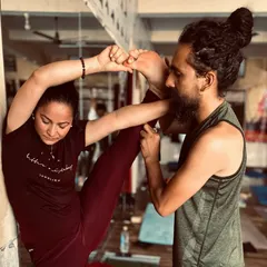 As part of our teacher training, I provide hands-on adjustments to ensure students understand the nuances of each pose, like this standing split.