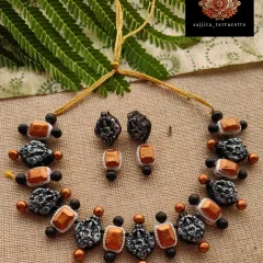 A fusion of temple and stone jewelry styles, this necklace features Lakshmi charms alongside copper-colored elements. This unique combination is great for customers looking for something traditional yet different.