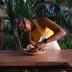 Me, working on a hand built piece in our lush, green studio space, a perfect environment for creativity to flourish.