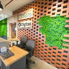 A creative moss wall feature at the Digitas office reception. Here, we integrated a patch of lush, preserved moss into an exposed brick wall, creating a striking contrast between natural and industrial textures.