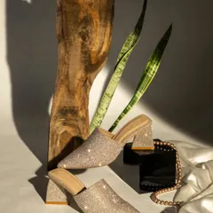 Here, I styled these sparkling block heels with natural wood and plant leaves to create a beautiful contrast between glamour and nature. The strong directional light makes the embellishments shine, highlighting the shoe's party-ready appeal.