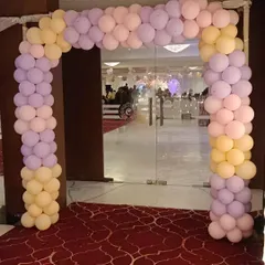 A pastel balloon arch frames the entrance to this event hall. Using soft shades of pink, purple, and yellow, I created a welcoming entryway that hints at the elegant celebration waiting inside.