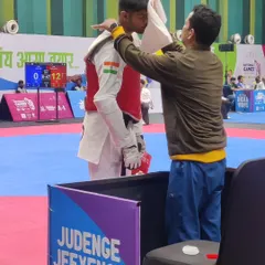 The role of a coach extends to the final moments before a match. Here I am offering final words of encouragement and strategy to a Karnataka athlete at the National Games.