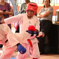 A student demonstrates a strong blocking technique during a competitive kumite match. We train our students to be defensively sound and strategically smart in tournaments.