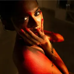 A close-up detail of the fire body paint, highlighting the brushwork and blending on the shoulder and face. The wet-look hair adds to the elemental feel of the character.