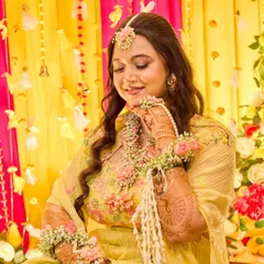 This portrait showcases the bride's complete Haldi look. I focused on her serene expression and the delicate floral jewelry that complements her yellow outfit.