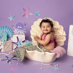 Diving into a world of imagination with this adorable mermaid session. My studio is filled with enchanting props like this seashell to bring your little one's fairytale dreams to life.