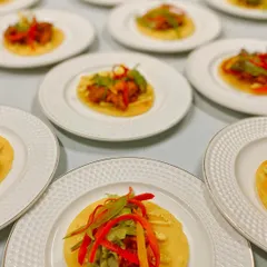 Our food is a feast for the eyes as well as the palate. These vibrant Chicken Garlic Mini Tacos, artfully plated, represent our modern approach to Indian fusion cuisine, where familiar flavors are presented with contemporary flair.