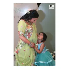 A touching moment between the mother-to-be and a young family member, looking up at her with adoration. These interactions show the love that surrounds a new baby.