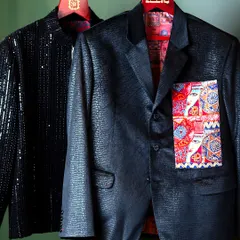 Our bespoke services cater to a wide range of styles, from understated to bold. This image displays two distinct statement jackets: one in a shimmering black sequined fabric and another in a textured material with a uniquely patterned pocket detail.