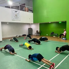 The entire group, young and old, engaging in a plank challenge. Core strength is a fundamental part of my training philosophy for players at all levels to improve balance and power.