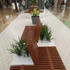 For this wide corridor at Lulu Hypermarket, I designed these modern slatted wood benches with built-in planters. This solution adds comfortable seating and greenery without cluttering the walkway, using artificial grasses for a clean, no-maintenance look.