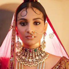 A close-up on bridal beauty. I worked with the makeup artist to create this look, focusing on the traditional "chandrakor" bindi and a statement navratna choker. This highlights my holistic approach, ensuring makeup, hair, and jewellery work in perfect harmony.