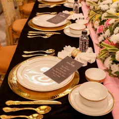 A closer look at our detailed table arrangements. We use hammered gold charger plates, premium cutlery, and custom menu cards to create a setting that makes every guest feel like an honoree.