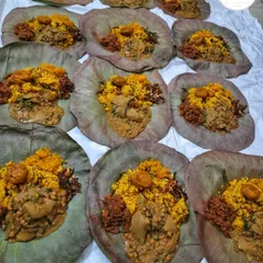 Preparing dozens of Khechri meals on lotus leaves during the busy Kang season in Delhi. It's a lot of work, but worth it to see our customers happy.